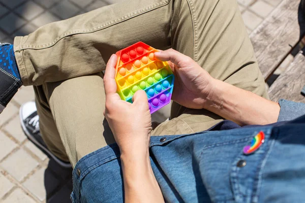 Man med regnbåge pop det leksak, lgbt bricka, stolthet månad — Stockfoto