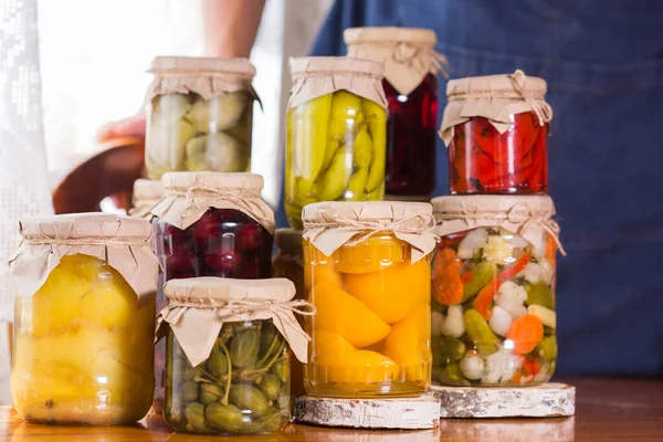 Young man holding in hands preserved food — Stock Photo, Image