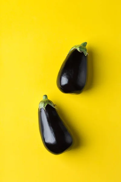 Eggplant or aubergine on yellow background, healthy eating concept — Stock Photo, Image