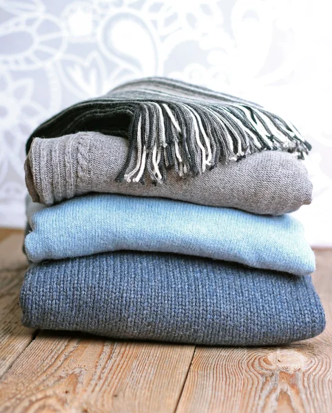 Pile of warm wool clothing on a wooden table — Stock Photo, Image