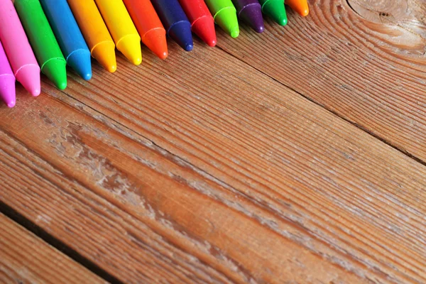 Copy space background with oil pastel crayons on a wooden table — Stock Photo, Image