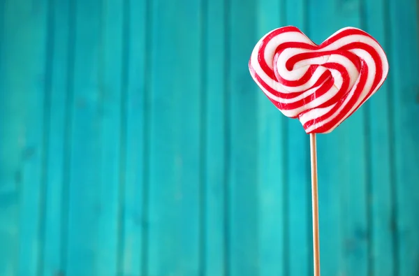 Heart shaped lollipop for Valentine's Day with turquoise backgro — Stock Photo, Image