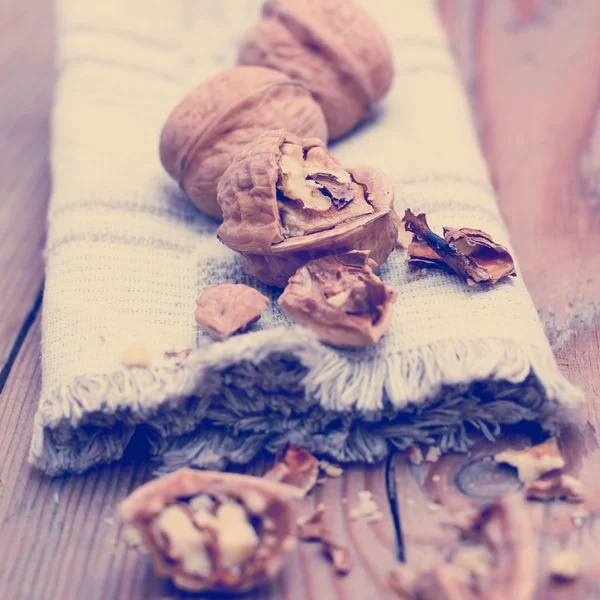 Walnuts and napkin on a table — Stock Photo, Image