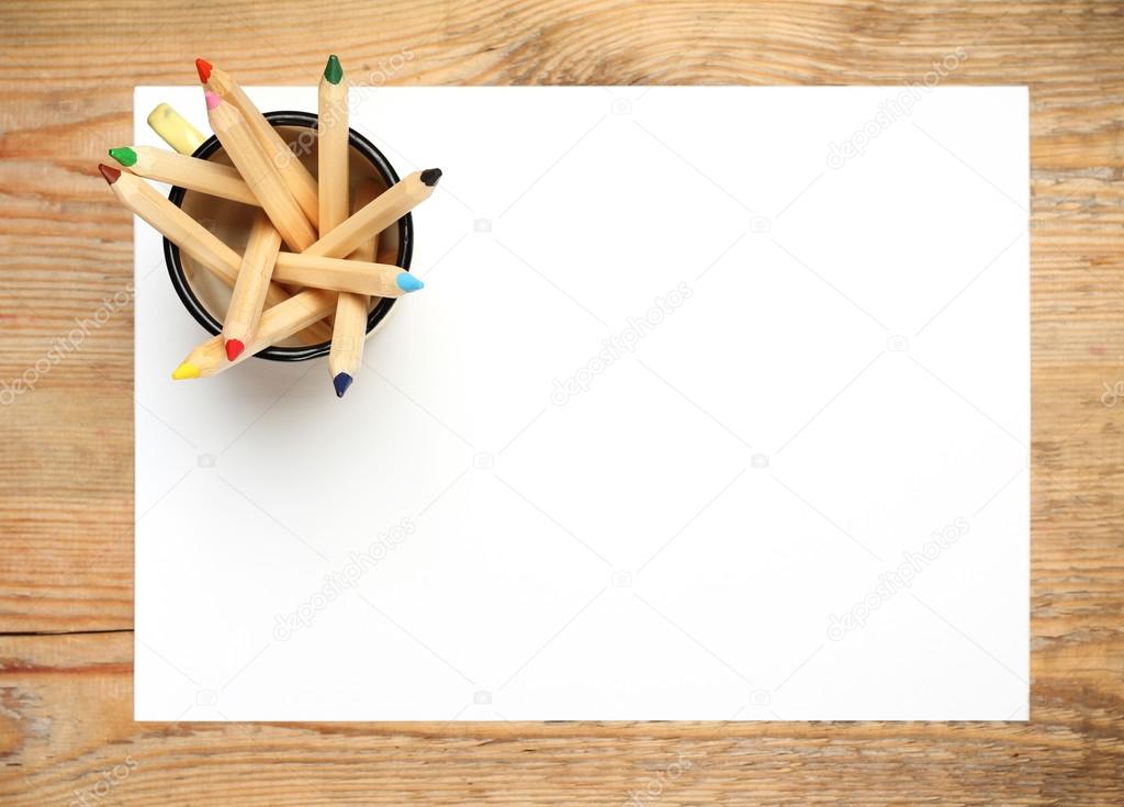 Pencils in a mug on a wooden table