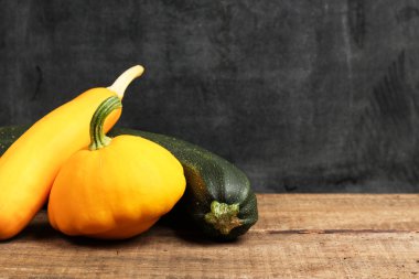 Pumpkin and zucchini on a wooden table