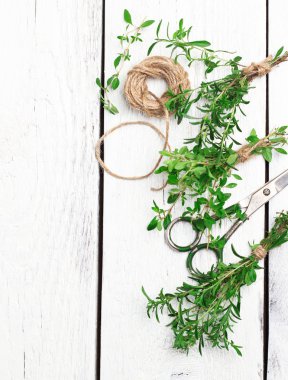 Mix of herbs on a wooden table, savory, thyme