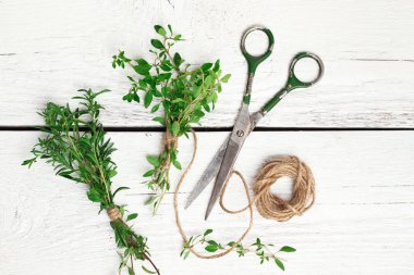 Mix of herbs on a wooden table, savory, thyme
