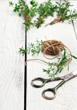 Fresh herbs (savory) on a wooden table