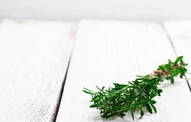 Fresh herbs (savory) on a wooden table