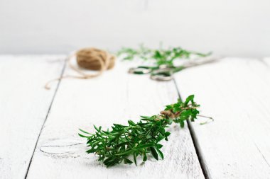 Fresh herbs (savory) on a wooden table
