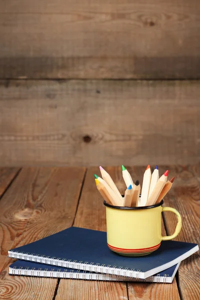 Bleistifte im Becher auf einem Holztisch — Stockfoto