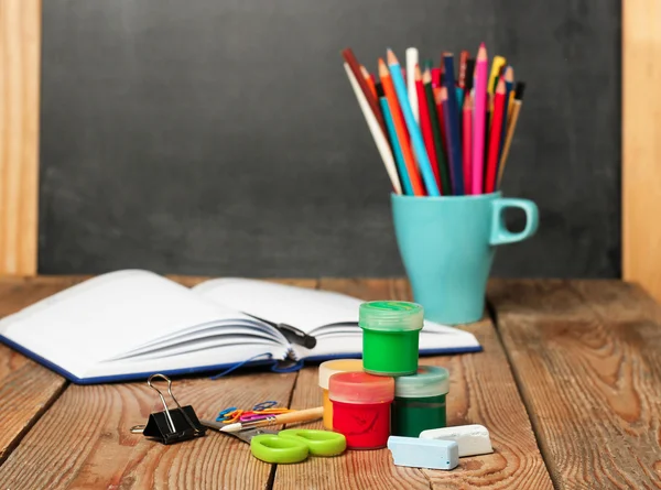 School supplies, open notebook and chalkboard — Zdjęcie stockowe