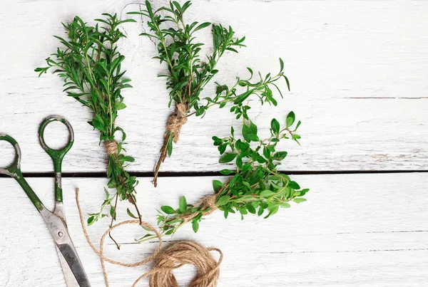 Mix of herbs on a wooden table, savory, thyme