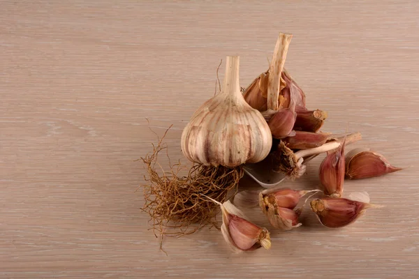 Garlic on a white background and a garlic press. Garlic grinding appliance.