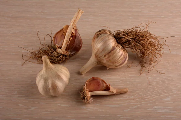 Garlic on a white background and a garlic press. Garlic grinding appliance.