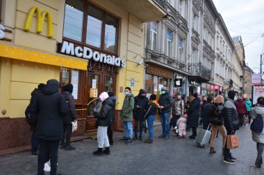 Lviv. Ukraine, January 2021.queue in McDonald Lviv.Queue near the Macdonalds in the quarantine and pandemic repield. Maintenance in takeaway mode.