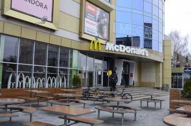 Rivne, Ukrayna - Mart 2021 Çağdaş McDonald 's Restoran Harici. McDonalds 'ın resimli başyazısı alışveriş merkezinin girişini imzalıyor. McDonald' s fast food restoranı - logolu pencere