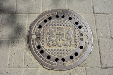 Lviv, Ukrayna. Temmuz 2021. Metal kanal kapaklı bir taş. Arkaplan dokusu olarak taş kaldırım. Taş bloklu kaldırım.