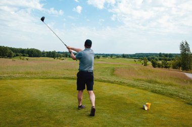 Profesyonel golf sahasında erkek golfçü. Golf sopasıyla vuruşan golfçü.