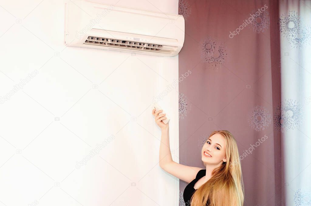 The girl push button power by finger of the air conditioner