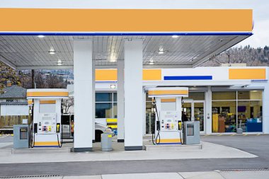 Gas station in white and orange clipart