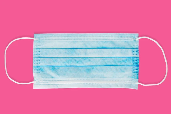 Disposable face mask with clipping path isolated on pink background