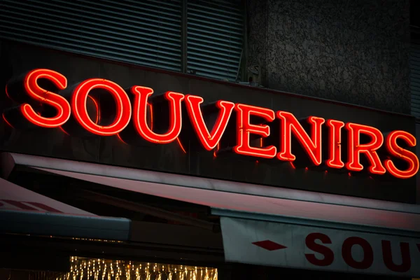 Red neon sign on souvenirs shop — Stock Photo, Image