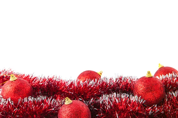 Red Christmas balls lying on tinsel — Stock Photo, Image