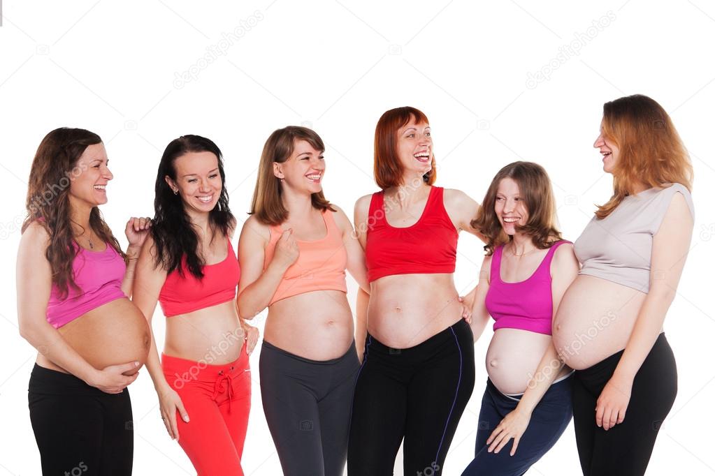 Six young happiness pregnant women, standing, talking and laughing. Maternity concept.