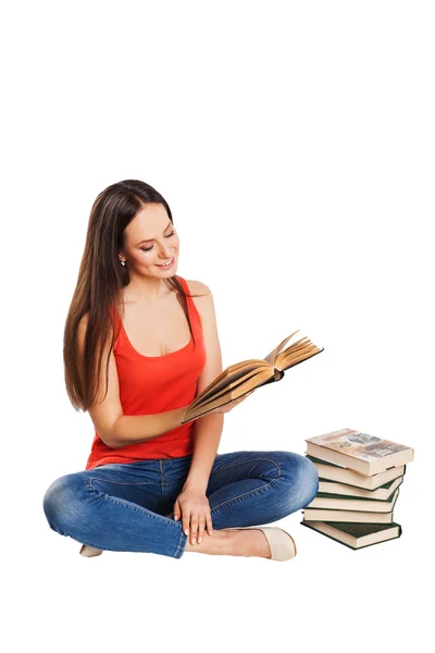 Beautiful young female student sitting on floor studying — Stock Photo, Image