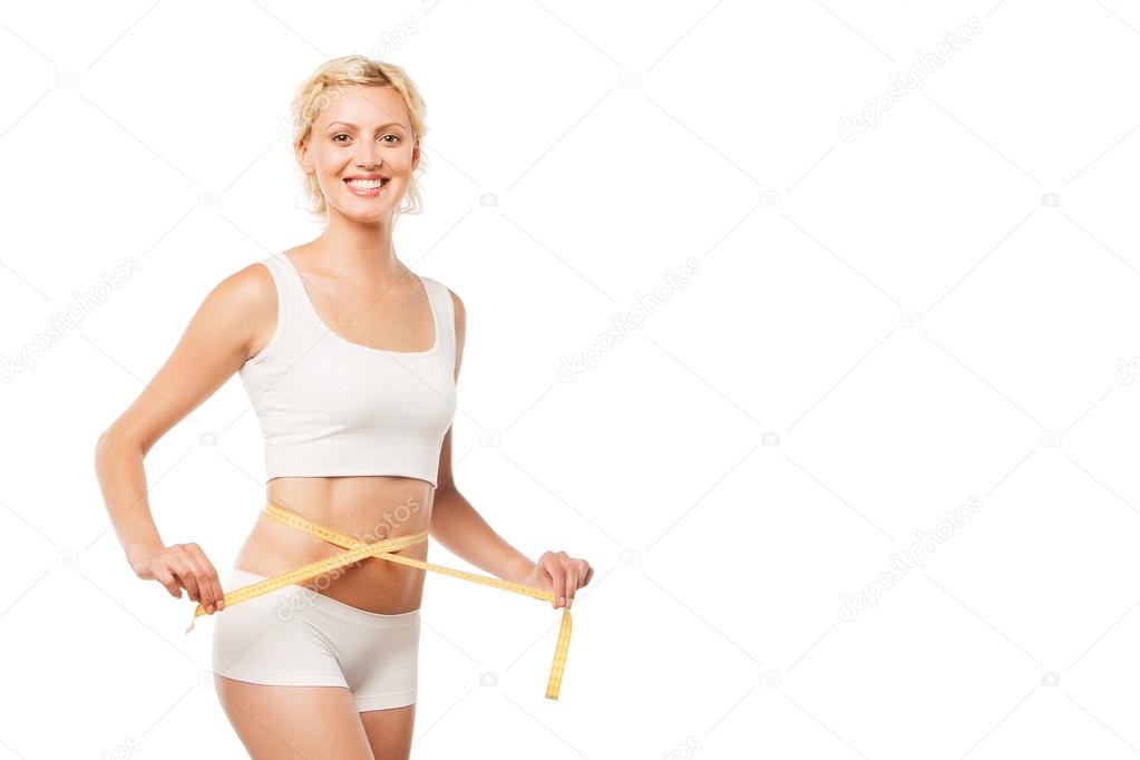 Happy smiling woman with a measuring tape over white