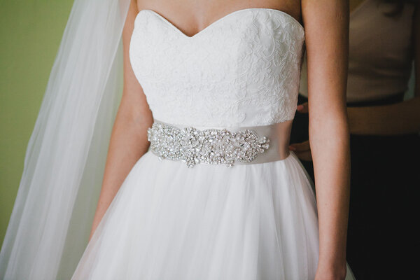 Фрагмент свадебного платья со стразами, украшенными ремнем
