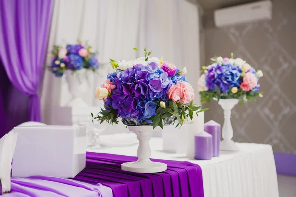 Hermosas flores y velas en la mesa en el día de la boda. Flores violetas . — Foto de Stock