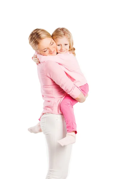 Smiling portrait of beautiful young mother with little pretty daughter - isolated on white. Happy family people concept. — Stock Photo, Image