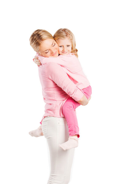 Smiling portrait of beautiful young mother with little pretty daughter - isolated on white. Happy family people concept.