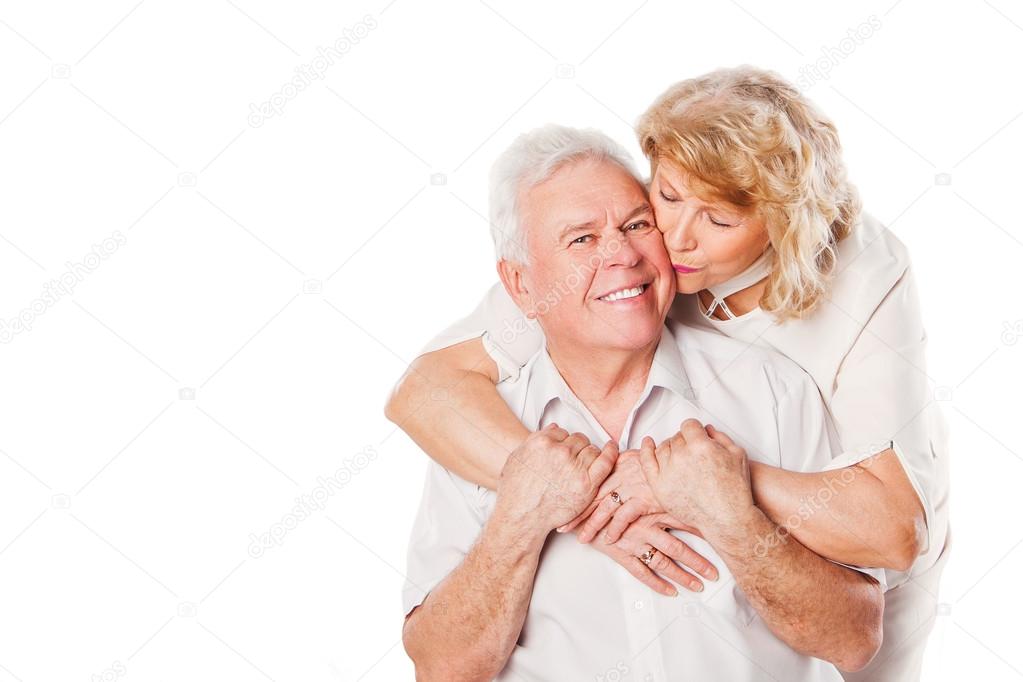 Portrait of happy seniors couple in love. Isolated over white background