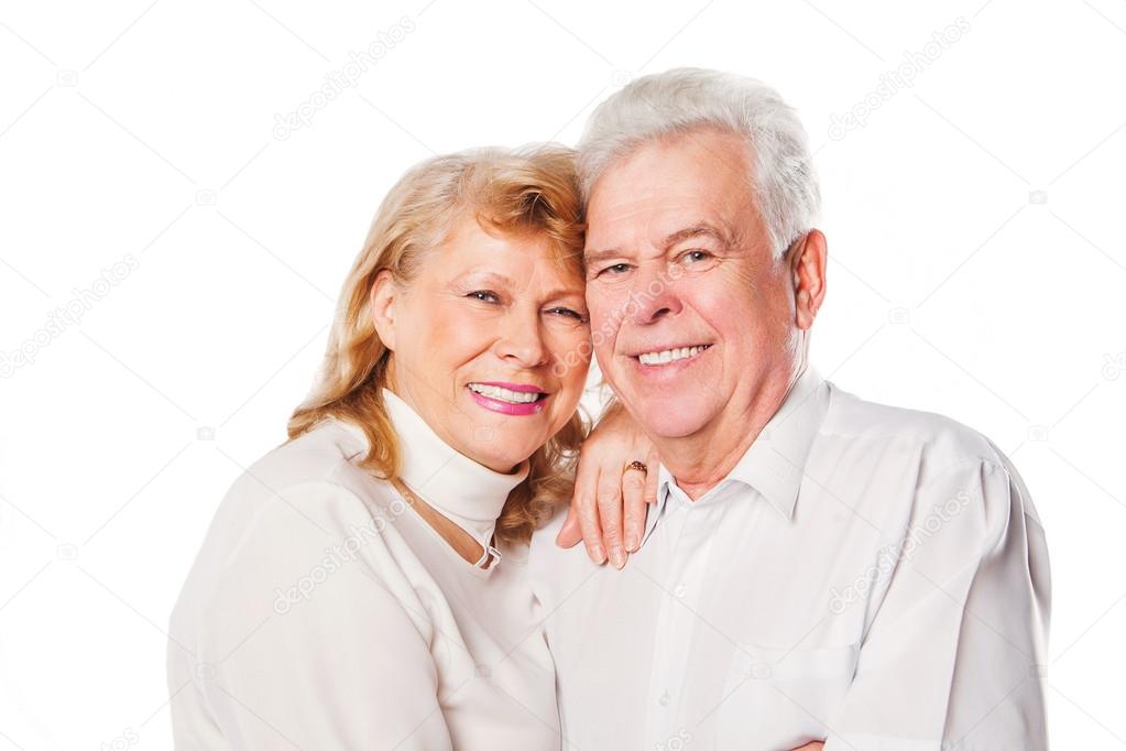 Close up of smiling senior couple in love. Isolated over white background.