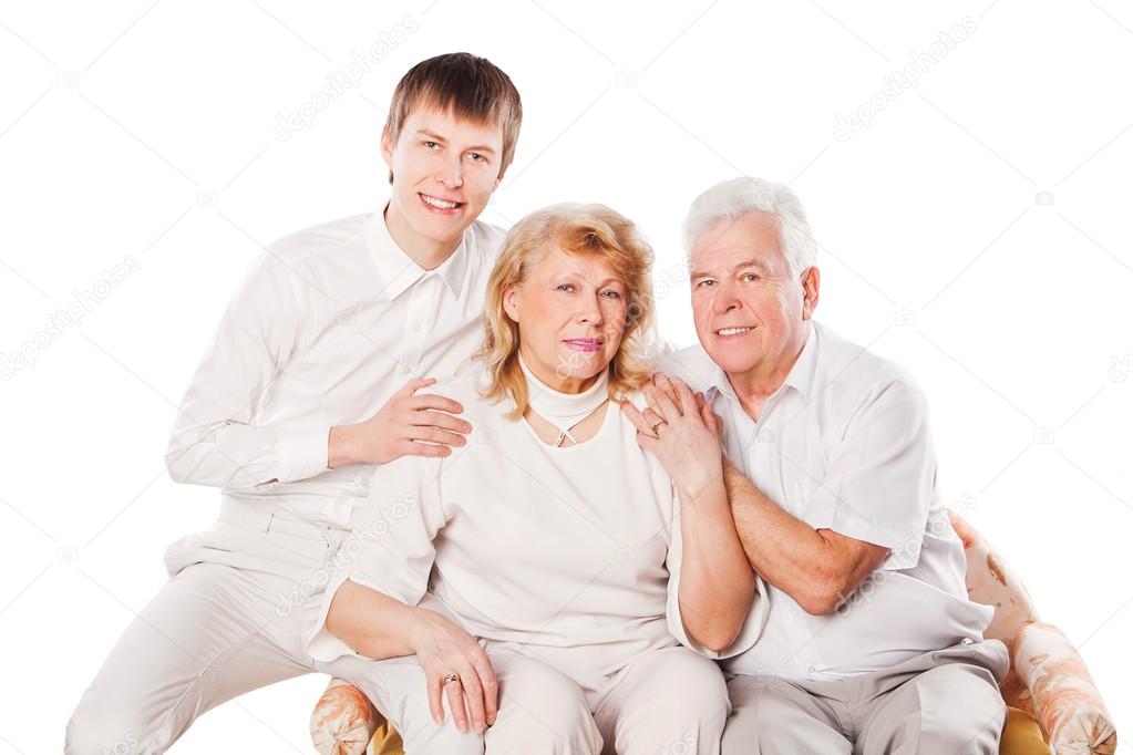 Portrait of happy senior couple and son on white background