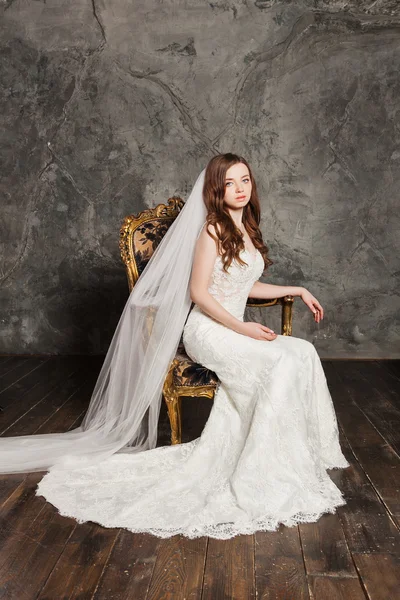 Photo of a beautiful smiling bride in luxurious wedding dress into elegant expensive interior — Stock Photo, Image