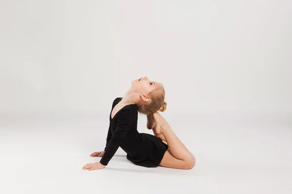 Kid girl gymnast on a white background — Stock Photo, Image