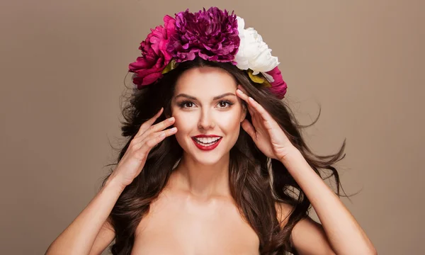 Modelo sexy com cabelo curle e flores brilhantes em sua cabeça — Fotografia de Stock