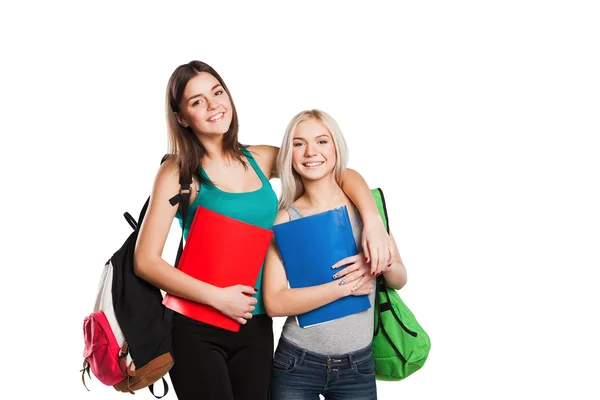 Two smiling students girl with school bags on their shoulders posing isolated — Stock Photo, Image