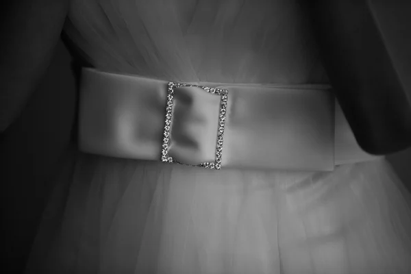 Close up of a wedding dress with large silk bow. Black and white photo — Stock Photo, Image