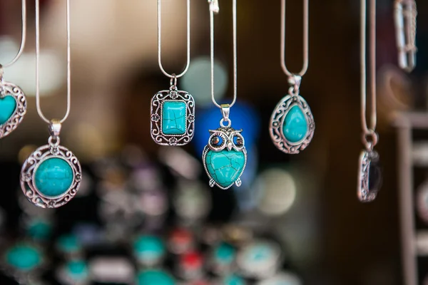 Hand made oval pendants with turquoise stone in a silver frame. — Stock Photo, Image