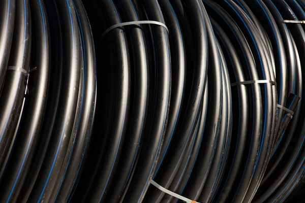 Background of black plastic pipes — Stock Photo, Image