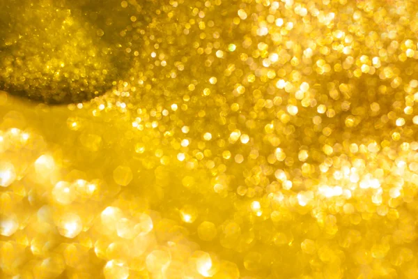 Fond abstrait de Noël aux paillettes dorées. Lumières dorées brillantes — Photo