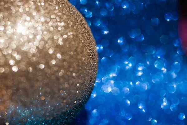 Golden christmas ball on glitter background Stock Photo