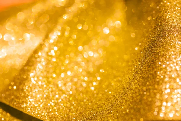 Christmas Golden Glittering background.Holiday Gold abstract texture