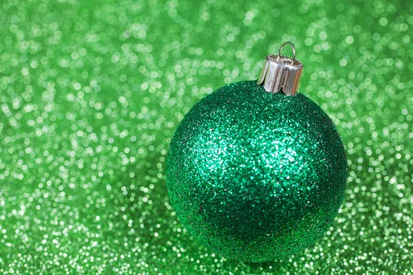 Christmas decorative green ball on glitter bokeh background — Stock Photo, Image