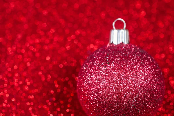 Christmas decorative ball on glitter bokeh background. — Stock Photo, Image